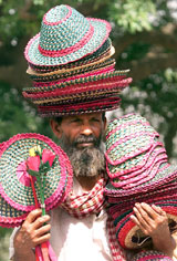 A vendor sells hats and fans on a hot day in New Delhi