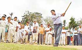 Former cricket player Kapil Dev plays with budding cricketers at the Sector 16 Cricket Stadium in Chandigarh on Tuesday. 