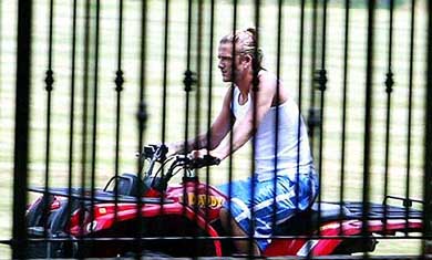 England and Manchester United soccer star David Beckham rides around the garden