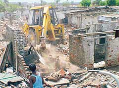 One of the bulldozers demolishes illegally constructed houses in Shaheed Bhagat Singh Colony in Sector 49