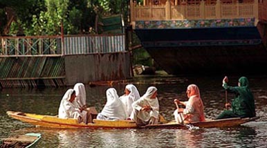 Women enjoy a boat ride in the Dal lake