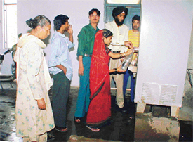 Relatives of patients queue up to get drinking water