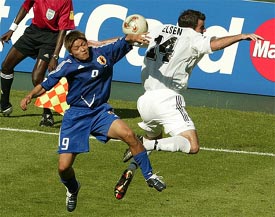 Japan's Yoshito Okubo and New Zealand's Ryan Nelsen fight for the ball