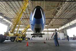 The fuselage of the Boeing 707 used as Air Force One by seven Presidents of the United States is lifted by two cranes