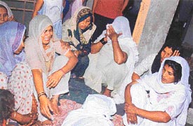 Women wail over the death of Rajesh who died after a scuffle with another boy