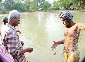 A professional diver spreads his net in a bid to fish out the body