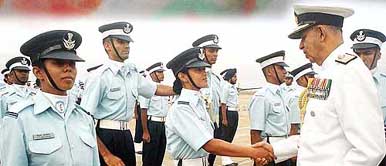 Chief of Naval Staff Madhvendra Singh shakes hand with a lady pilot officer