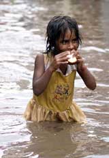 A girl eats a piece of bread