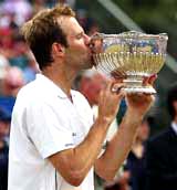 Britain's Greg Rusedski kisses the trophy after beating Mardy Fish of the US in the final of the Nottingham Open