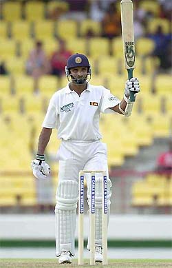 Marvan Atapattu of Sri Lanka raises his bat after reaching his century