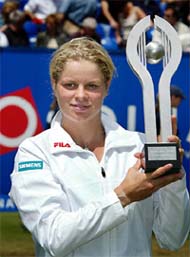 Kim Clijsters of Belgium holds the trophy after winning the final of the Ordina Open grasscourt tennis tournament 