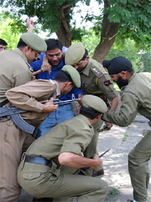 Policemen carry away Tehzim Dar 