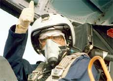 George Fernandes gives the thumbs up sign while sitting inside a Sukhoi-30