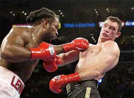 Vitali Klitschko of Ukraine takes a blow from WBC heavyweight champion Lennox Lewis