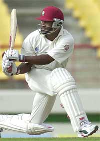 West Indies' captain Brian Lara hits a boundary off Muttiah Muralitharan 