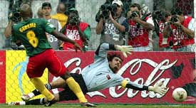 Turkey goalkeeper Rustu Recber dives in vain as Geremi of Cameroon scores from a penalty kick