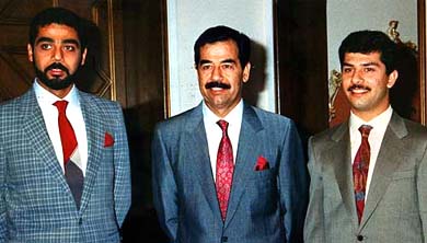 Saddam Hussein poses with his sons Uday and Qusay