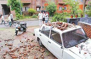 Bricks from the cantilever of a house fall on a car and damage it in Sector 39-D, Chandigarh