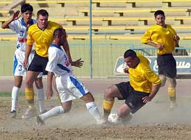An Iraqi team play a friendly match against a US army team