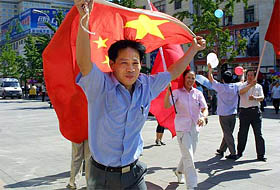 A Chinese man runs with the national flag during celebrations