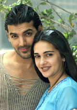 Film stars John Abraham and Tara Sharma pose for photographers