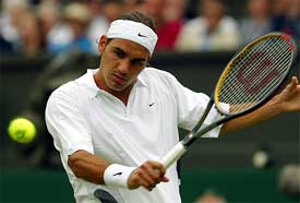 Switzerland's Roger Federer plays a return to Austria's Stefan Koubek