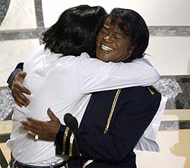 Singer Michael Jackson hugs Soul legend James Brown