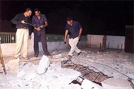 Forensic experts examine the house in Ahmedabad where a bomb detonated late on Wednesday