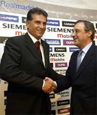 Real Madrid's new Portuguese coach Carlos Queiroz is greeted by the club's president Florentino Perez