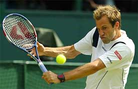 Britain's Greg Rusedski plays a return to Andy Roddick of the US