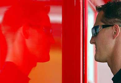 Ferrari's German Formula One World Champion Michael Schumacher is reflected on the wall of his team's motor home