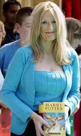 British author JK Rowling holds a copy of her fifth Harry Potter book, "The Order Of The Phoenix", as she arrives for a reading session at the Royal Albert Hall