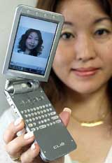 A Sony Corp employee displays the new 'CLIE PEG-NX80V' Personal Digital Assistant