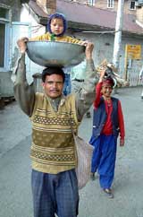 A migrant labour family returns to their home after a hard day's of work