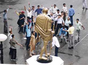 Tourists enjoy the rain at the Ridge in Shimla