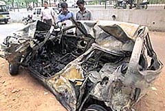 The ill-fated car which caught fire after a truck rammed it at the Moti Nagar crossing in the Capital on Friday morning. Two students of the Delhi University perished in the mishap