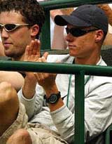 Australia's Lleyton Hewitt watches his girlfriend Kim Clijsters of Belgium playing against Samantha Reeves of the US 