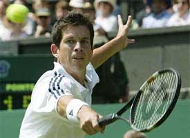 Britain's Tim Henman returns to Michael Llodra of France