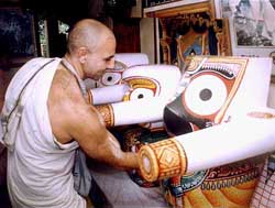 Idols of Lord Jagannath, Balabhadra and Subhadra being cleaned by ISKCON devotee at Ranaghat, near Mayapur