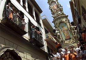 Nola villagers dance and sing on the 25-metre high wooden obelisk