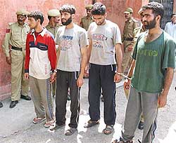 The police present four Harkat-ul-Jehadi Islamami militants before the media in Jammu 