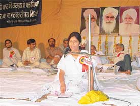 A participant presents couplets at a mushaira