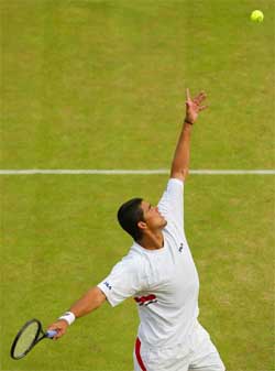 Australia's Mark Philippoussis serves to Andre Agassi of the US
