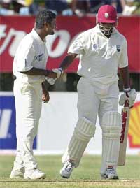 Muttiah Muralitharan of Sri Lanka congratulates West Indies captain Brian Lara