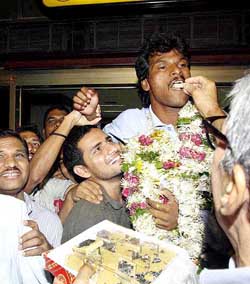 Jubilant admirers carry Indian hockey captain Dhanraj Pillai