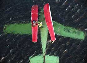Rescuers prepare to winch Ole Julius Eriksen from his crashed seaplane