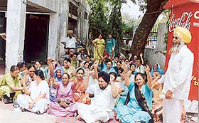 The para-medical staff of the Health Department sit on a protest dharna in Ludhiana on Wednesday. 