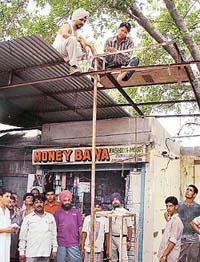 Shopkeepers remove their sheds themselves at the Sector 15 booth market in Chandigarh on Thursday