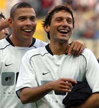Real Madrid's Brazilian striker Ronaldo smiles with compatriot Leonardo  of AC Milan