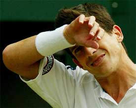 Britain's Tim Henman wipes his brow during his quarterfinal match against Sebastien Grosjean of France